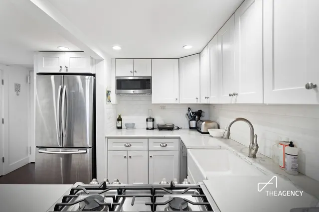 a kitchen with stainless steel appliances a refrigerator sink and cabinets