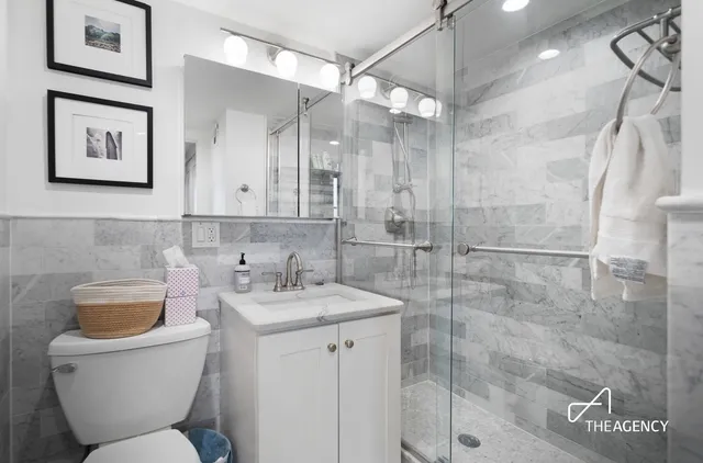 a bathroom with a toilet sink and shower