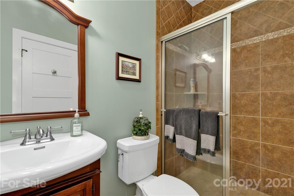 253 Benitez Way Clyde, NC 28721 - Photo 12 of 40 a bathroom with a sink toilet and shower