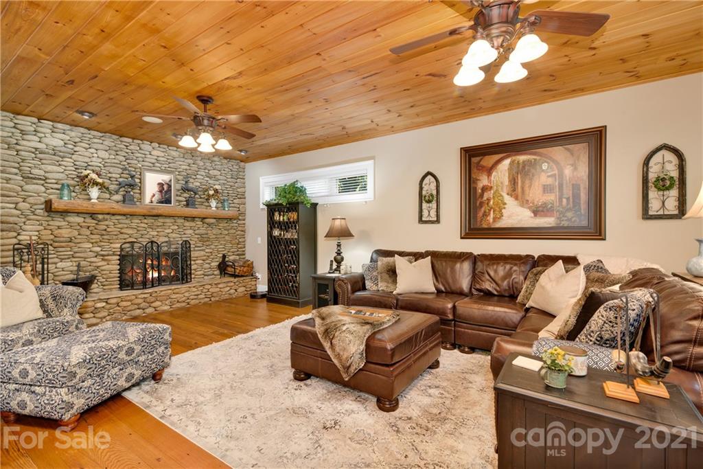 253 Benitez Way Clyde, NC 28721 - Photo 13 of 40 a living room with furniture and a flat screen tv