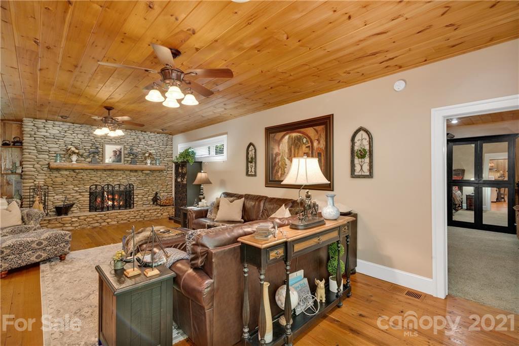 253 Benitez Way Clyde, NC 28721 - Photo 14 of 40 a living room with fireplace furniture and a flat screen tv