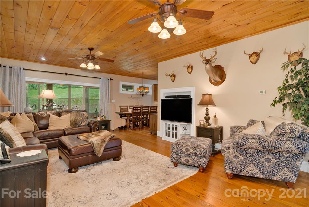 253 Benitez Way Clyde, NC 28721 - Photo 15 of 40 a living room with furniture and a flat screen tv