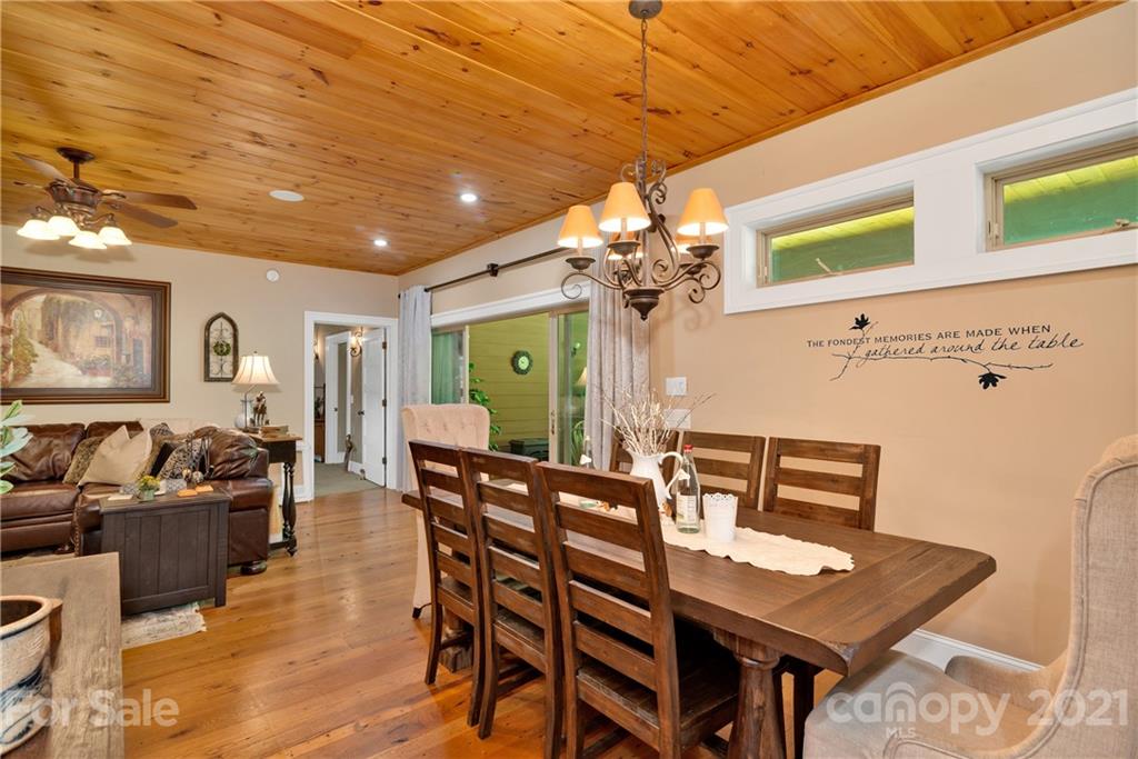 253 Benitez Way Clyde, NC 28721 - Photo 16 of 40 a view of a dining room with furniture and a chandelier