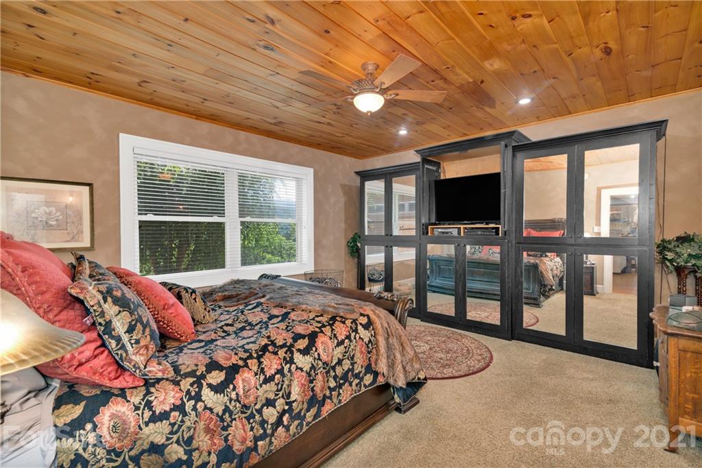 253 Benitez Way Clyde, NC 28721 - Photo 20 of 40 a bed sitting in a spacious bedroom next to a window