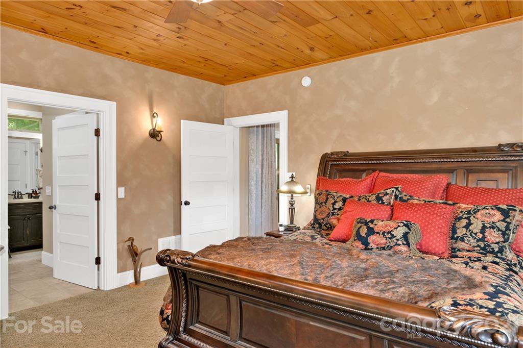 253 Benitez Way Clyde, NC 28721 - Photo 21 of 40 a bedroom with a bed and a dresser