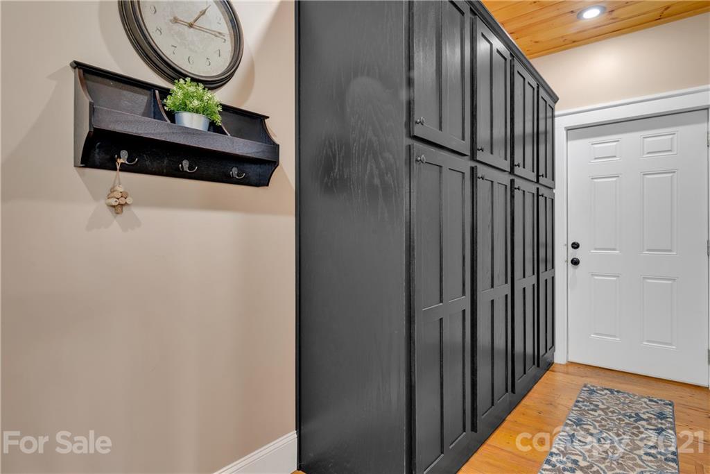 253 Benitez Way Clyde, NC 28721 - Photo 22 of 40 a picture of a hallway with wooden floor
