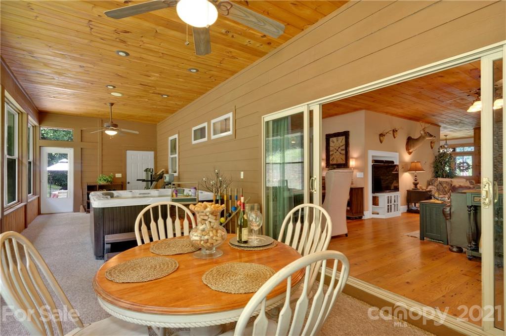 253 Benitez Way Clyde, NC 28721 - Photo 25 of 40 a dining room with furniture a wooden floor and chandelier