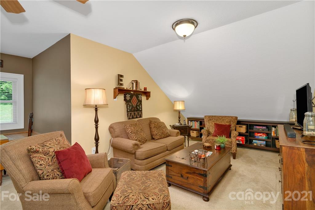 253 Benitez Way Clyde, NC 28721 - Photo 28 of 40 a living room with furniture and a flat screen tv