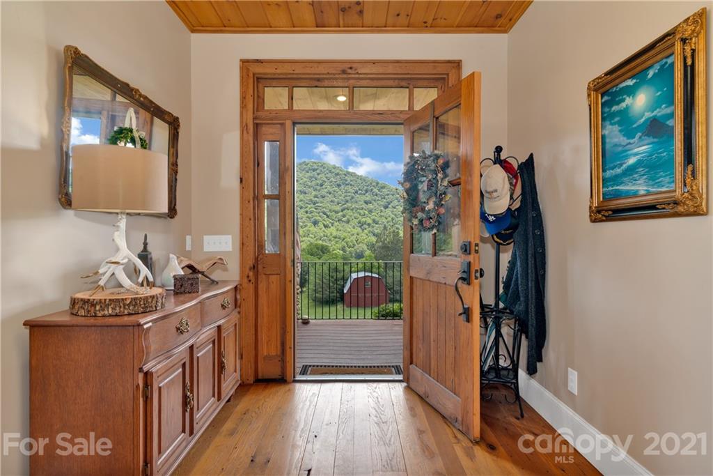 253 Benitez Way Clyde, NC 28721 - Photo 5 of 40 a view of a hallway with wooden floor and door
