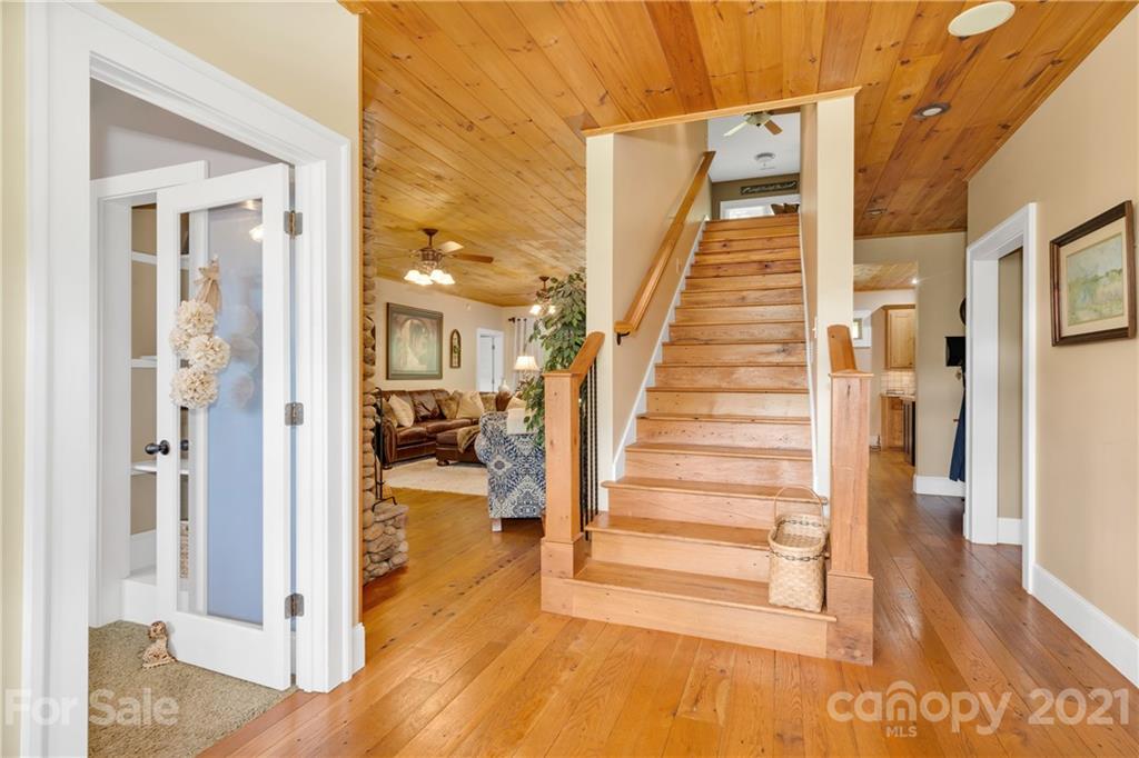 253 Benitez Way Clyde, NC 28721 - Photo 6 of 40 a view of a hallway with wooden floor and entryway
