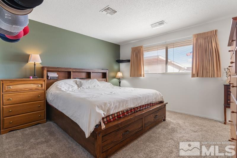 613 Ivy Street Carson City, NV 89703 - Photo 16 of 25 a bed room with a bed and window