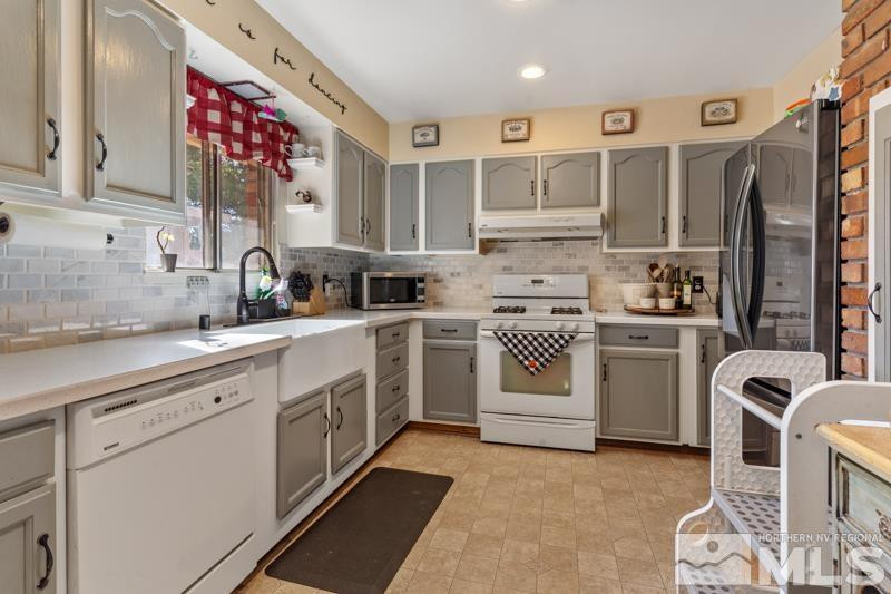 613 Ivy Street Carson City, NV 89703 - Photo 8 of 25 a kitchen with white cabinets and white appliances
