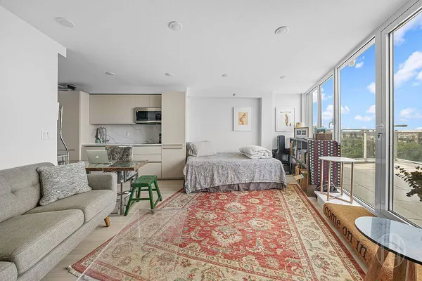 a bedroom with furniture and a large window