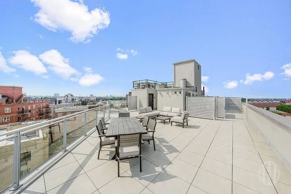 a view of a terrace with outdoor seating and city view