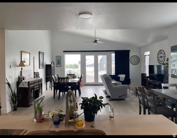 655 Oliver Road Tooele, UT 84074 - Photo 4 of 21 Open-concept living space featuring vaulted ceilings and light wood-finish flooring