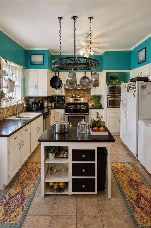 2405 Meriwether Road Shreveport, LA 71108 - Photo 4 of 20 a kitchen with stainless steel appliances granite countertop a stove and a refrigerator