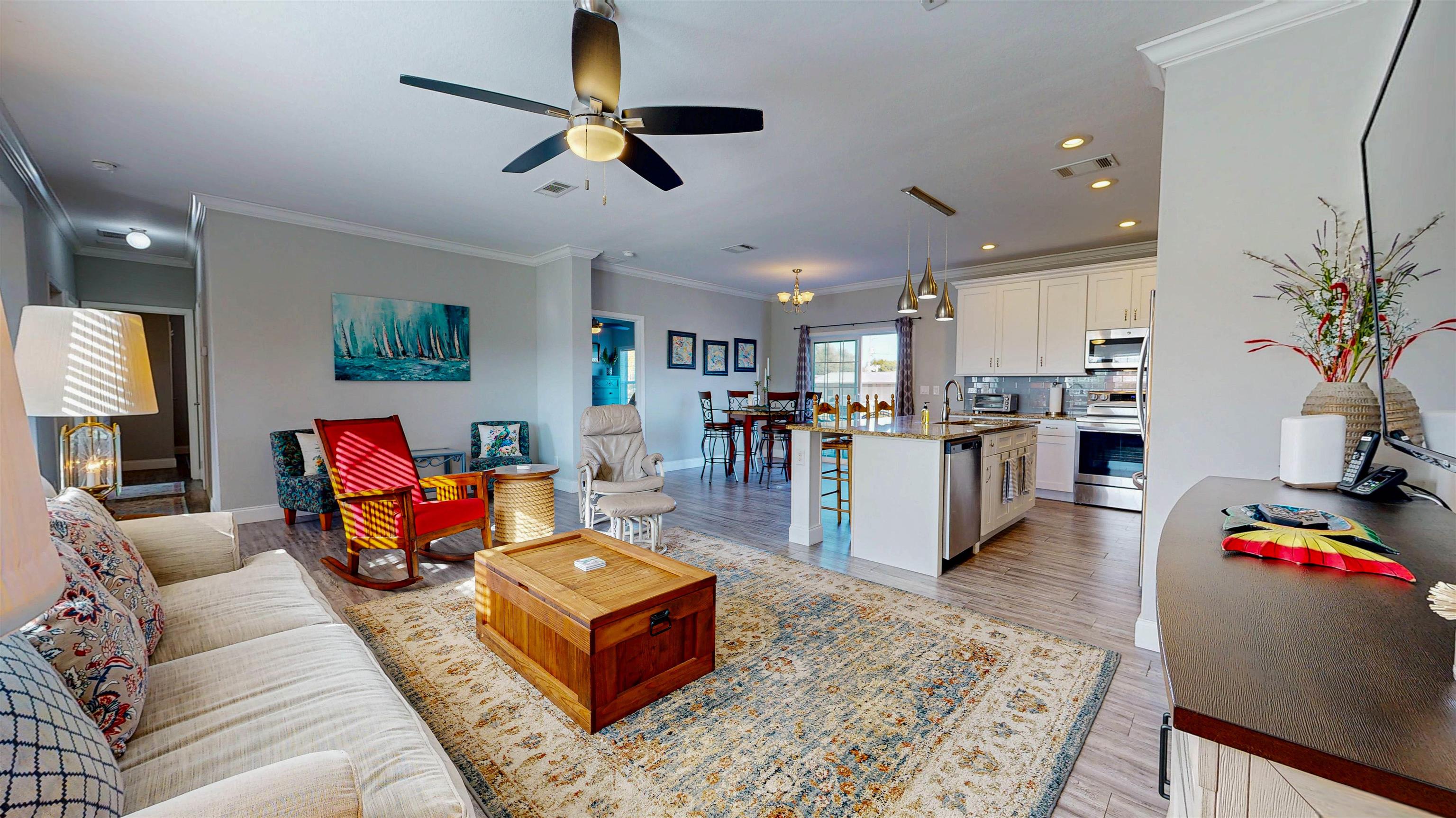 5910 Rio Royalle Road St. Augustine, FL 32080 - Photo 12 of 48 a living room with furniture kitchen view and a wooden floor