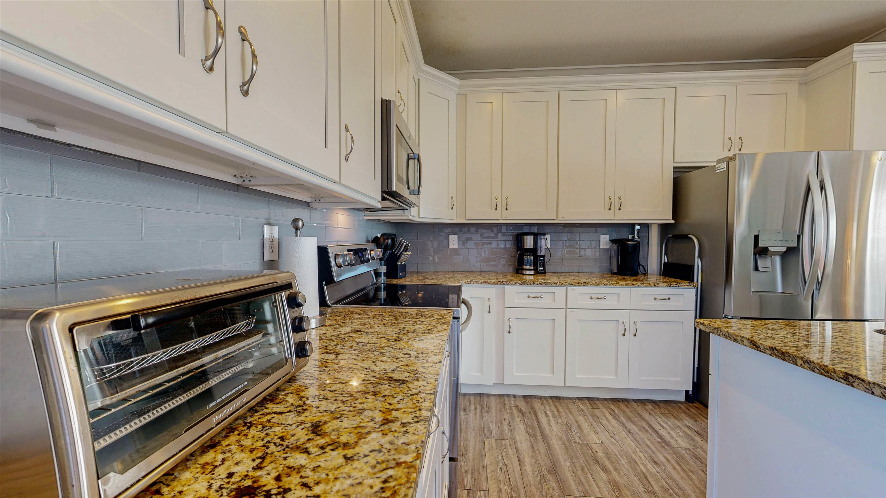 5910 Rio Royalle Road St. Augustine, FL 32080 - Photo 16 of 48 a kitchen with stainless steel appliances granite countertop a stove a sink and a refrigerator