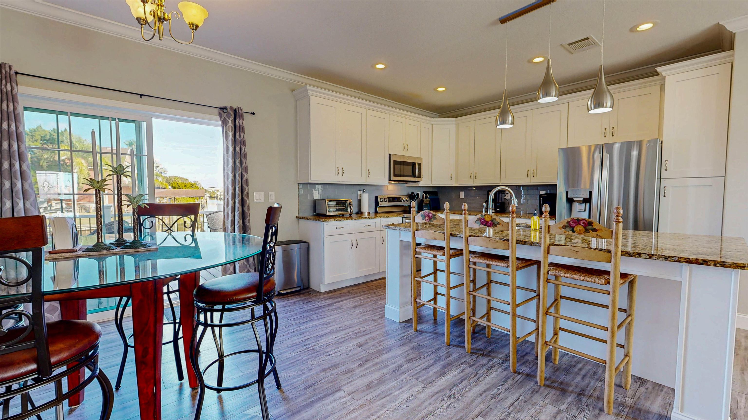 5910 Rio Royalle Road St. Augustine, FL 32080 - Photo 18 of 48 a view of a dining room with furniture window and wooden floor