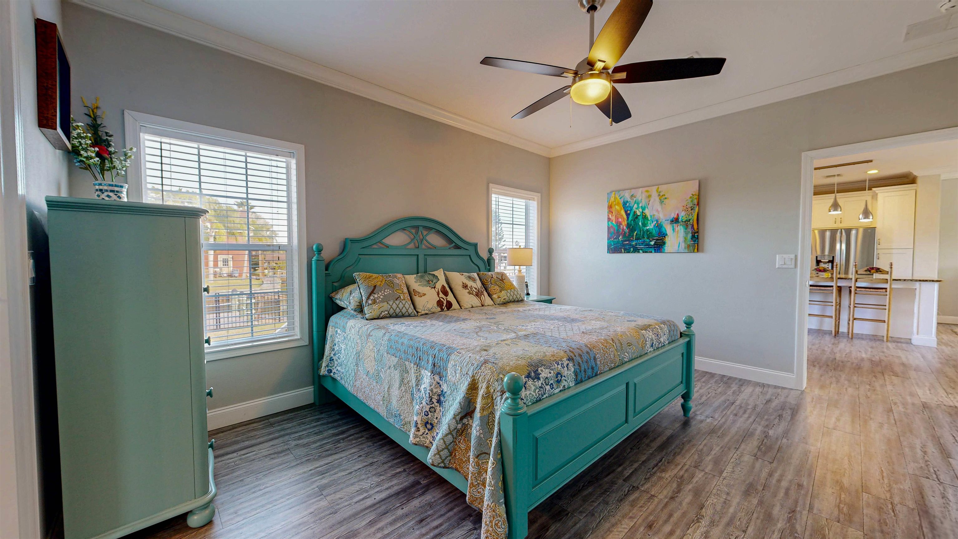 5910 Rio Royalle Road St. Augustine, FL 32080 - Photo 21 of 48 a bedroom with a bed a window and a chandelier