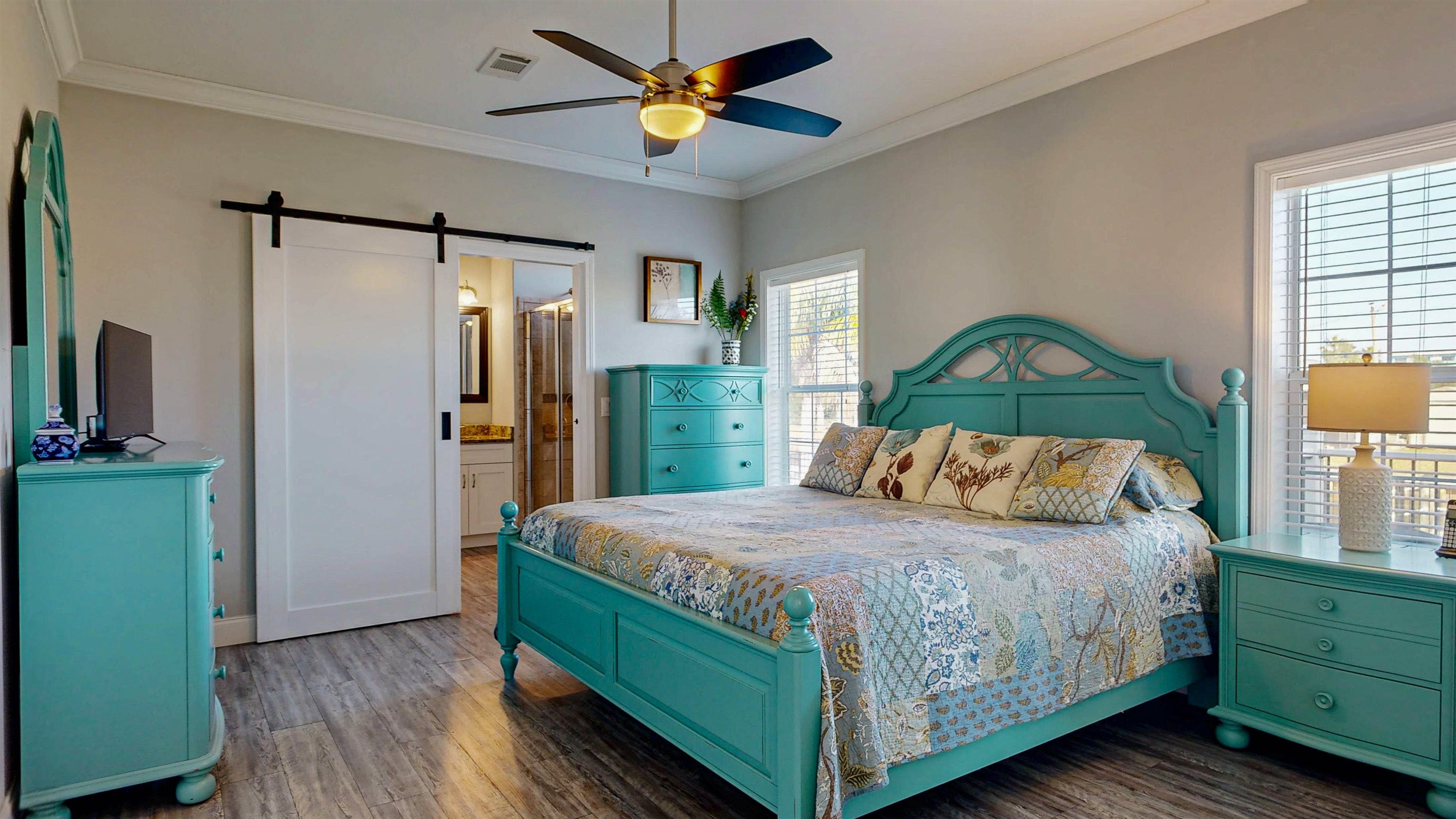 5910 Rio Royalle Road St. Augustine, FL 32080 - Photo 24 of 48 a bedroom with a bed and a chandelier
