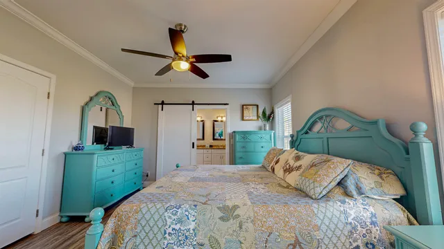 a bedroom with a bed and a mirror on the dresser