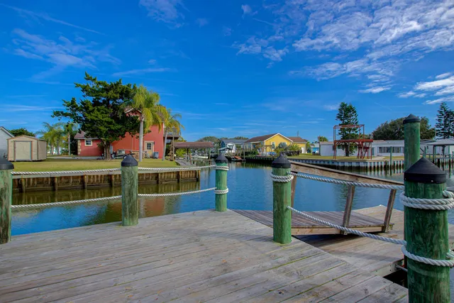 an aerial view of a house with garden space and street view
