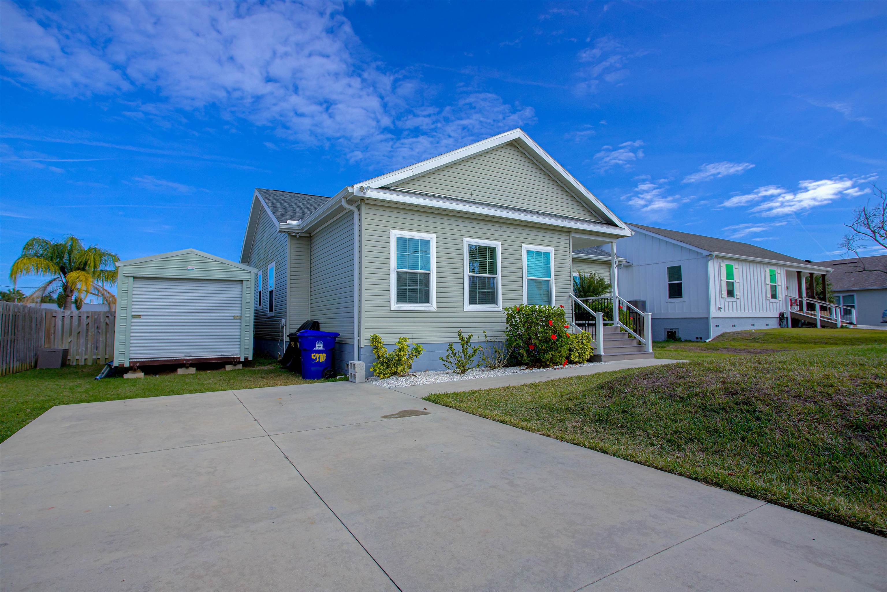 5910 Rio Royalle Road St. Augustine, FL 32080 - Photo 45 of 48 a front view of a house with a yard and garage