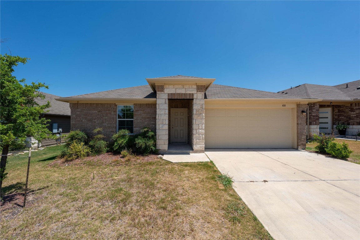 414 Pentire Way Hutto, TX 78634 - Photo 1 of 26 a front view of a house with a yard