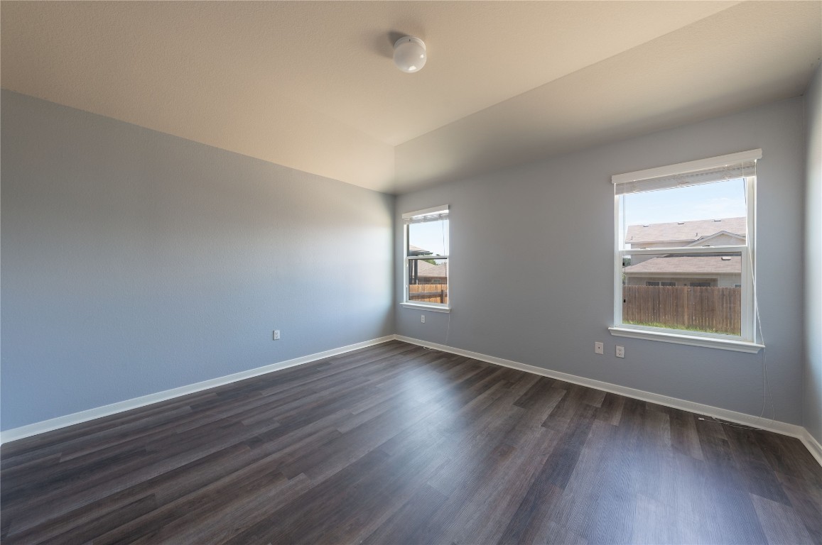 414 Pentire Way Hutto, TX 78634 - Photo 13 of 26 an empty room with wooden floor and windows