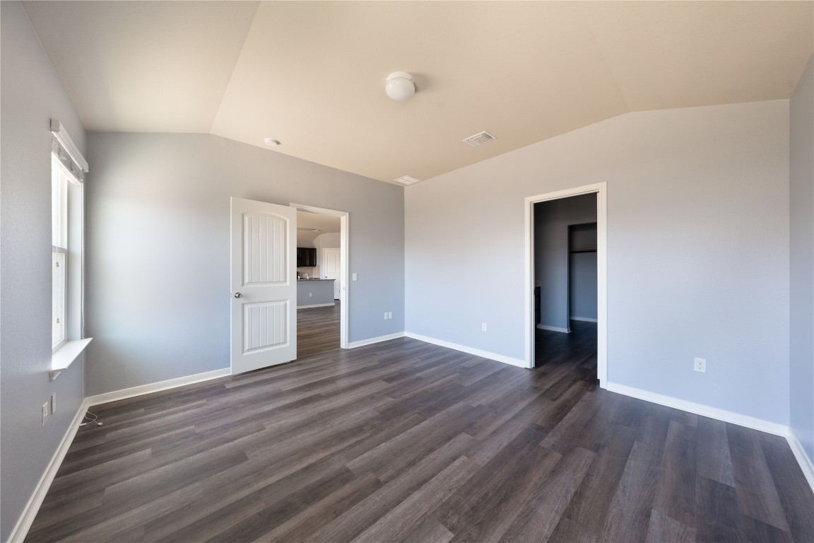414 Pentire Way Hutto, TX 78634 - Photo 14 of 26 a view of an empty room with window and wooden floor