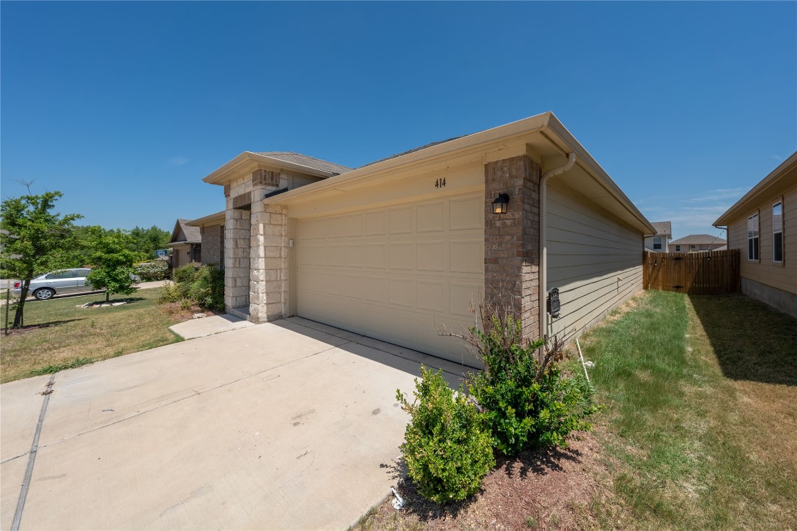 414 Pentire Way Hutto, TX 78634 - Photo 2 of 26 a backyard of a house with garden