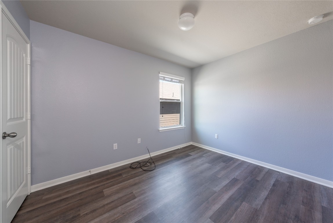 414 Pentire Way Hutto, TX 78634 - Photo 6 of 26 an empty room with wooden floor and windows