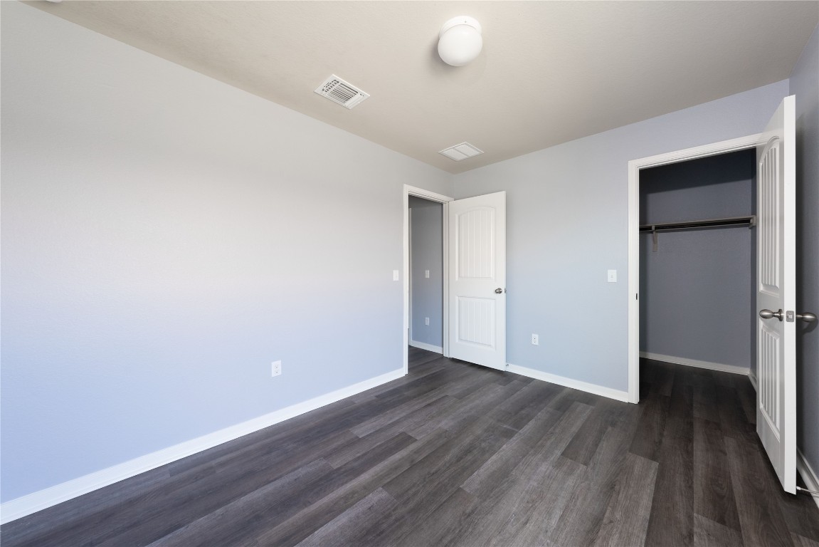 414 Pentire Way Hutto, TX 78634 - Photo 7 of 26 a view of an empty room with wooden floor