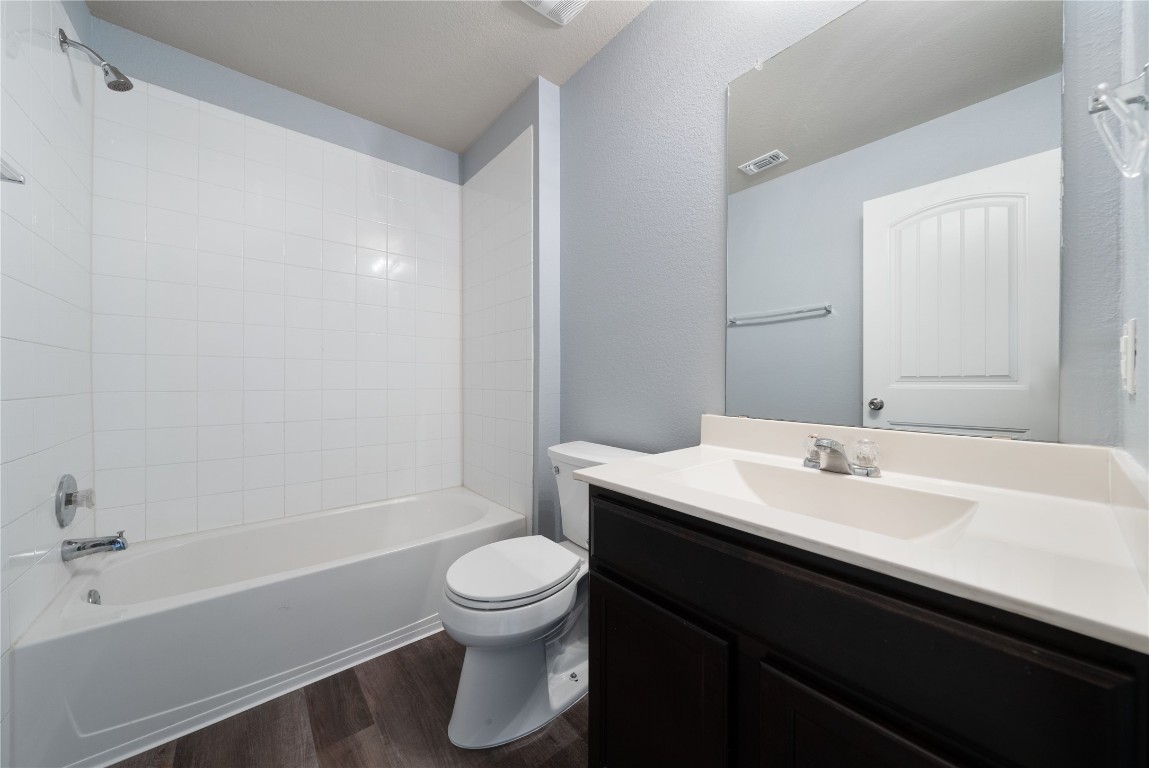 414 Pentire Way Hutto, TX 78634 - Photo 8 of 26 a bathroom with a sink a toilet and shower