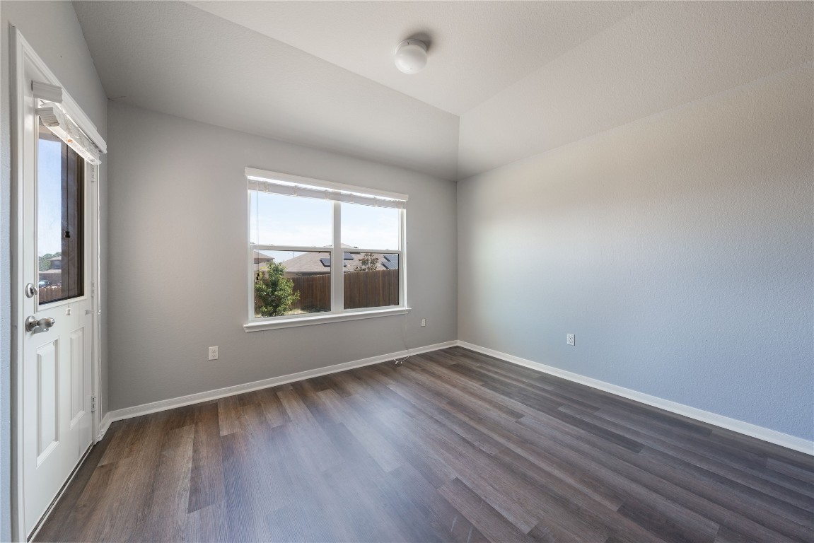 414 Pentire Way Hutto, TX 78634 - Photo 9 of 26 an empty room with wooden floor and windows