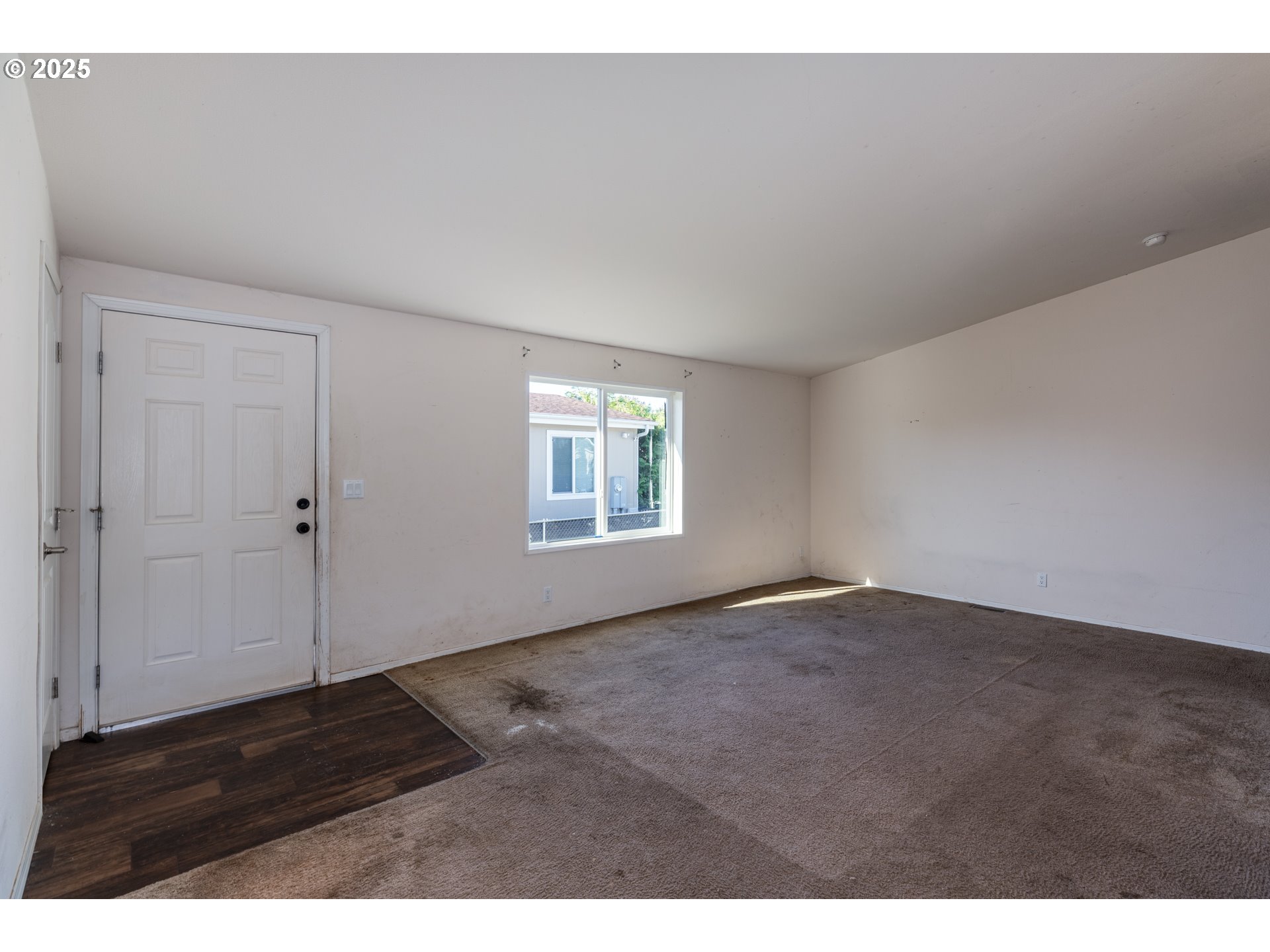 2154 Oregon Street, Unit 25 St. Helens, OR 97051 - Photo 6 of 11 a view of an empty room with wooden floor and a window