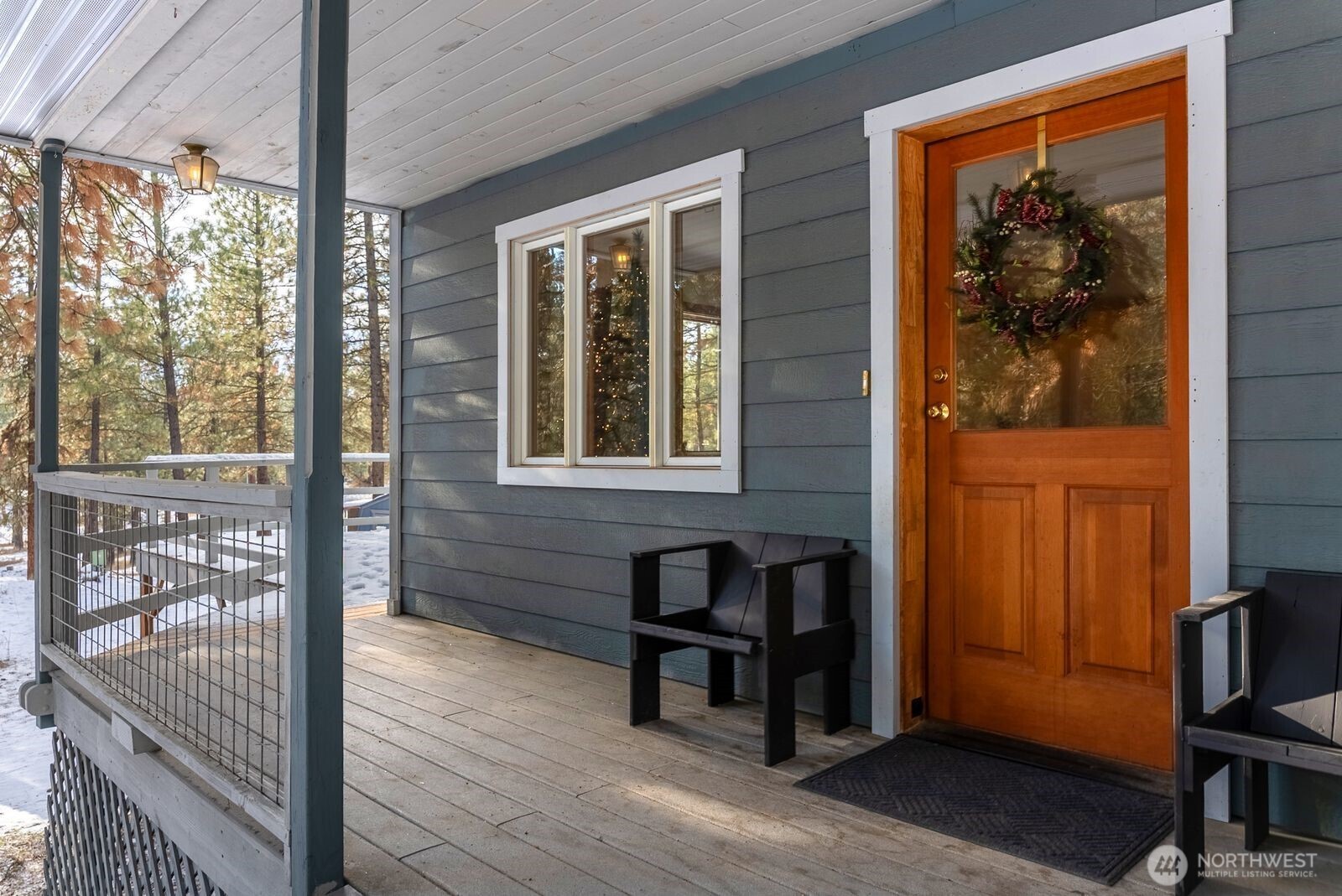 a view of front door and porch with wooden floor