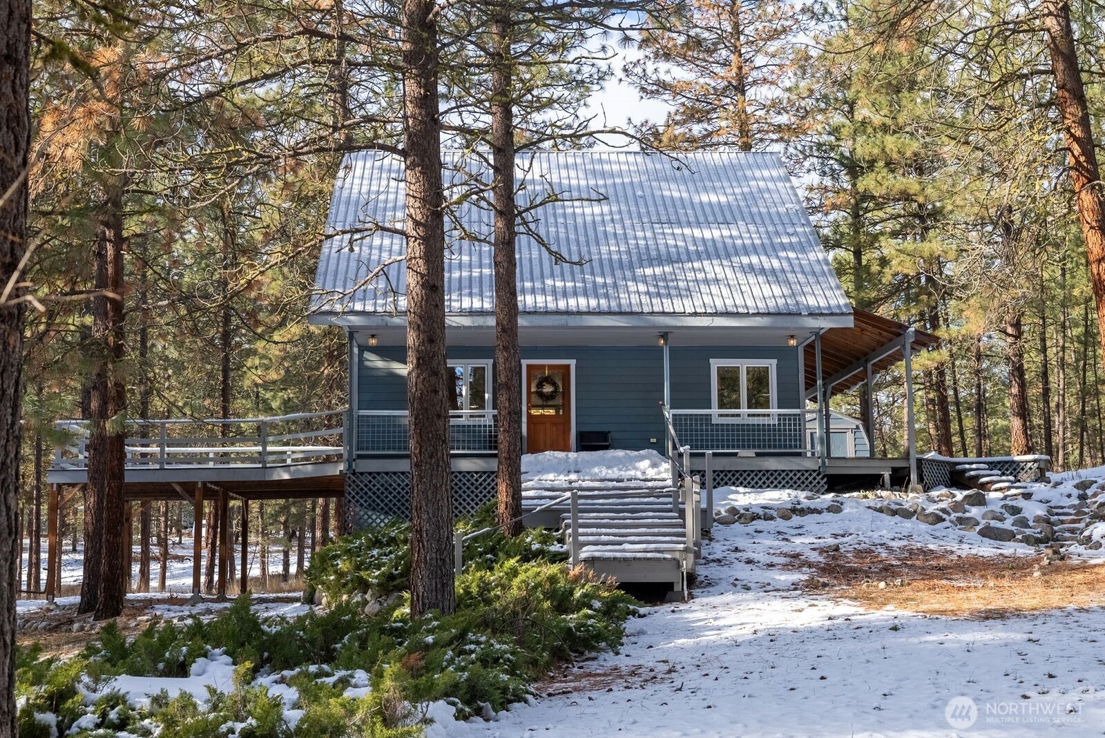 5 Chase Road Winthrop, WA 98862 - Photo 2 of 40 a front view of a house with a garden and tree