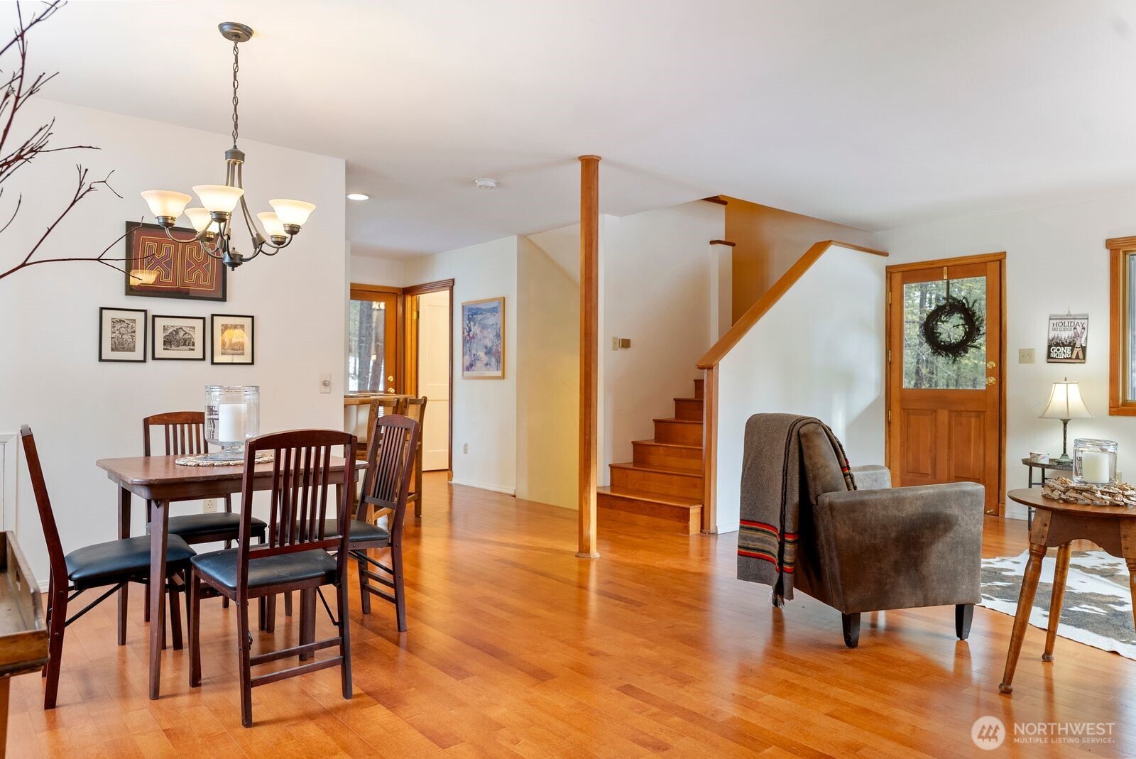 5 Chase Road Winthrop, WA 98862 - Photo 24 of 40 a view of dining room and livingroom with furniture wooden floor a rug a painting and a chandelier