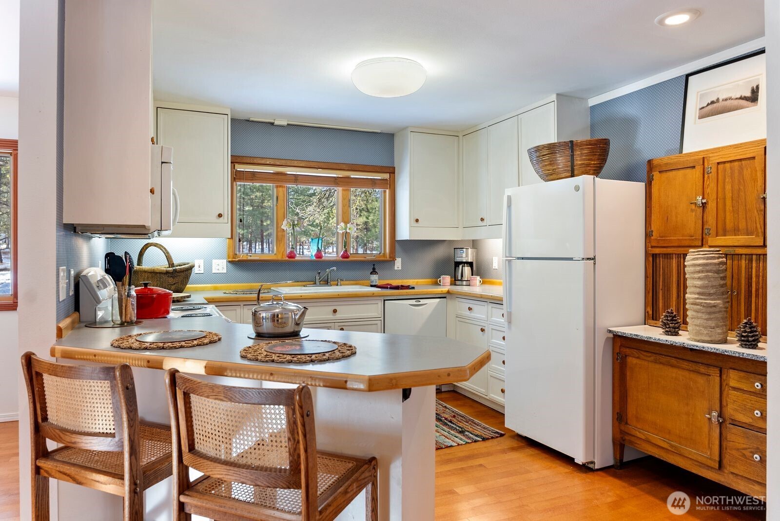 5 Chase Road Winthrop, WA 98862 - Photo 6 of 40 a kitchen with stainless steel appliances granite countertop a stove a refrigerator and a dining table with wooden cabinet
