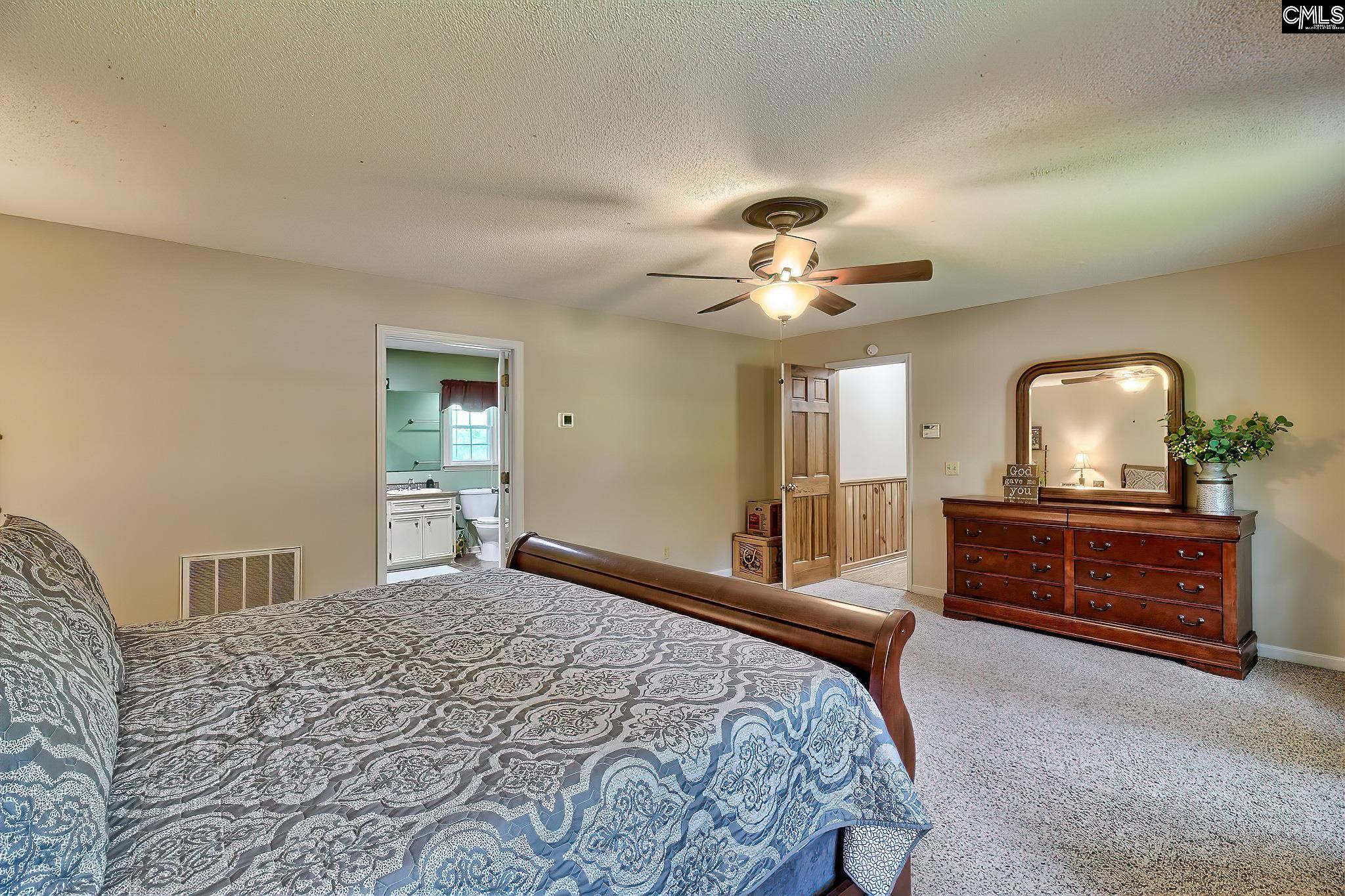 1415 State Rd S-28-55 Lugoff, SC 29078 - Photo 36 of 39 a bedroom with a bed and a dresser