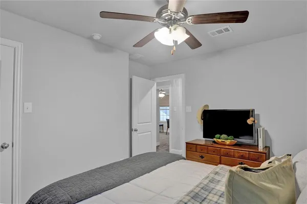 a bedroom with furniture and a flat screen tv