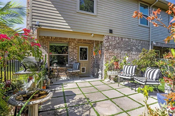a view of a patio with table and chairs and potted plants