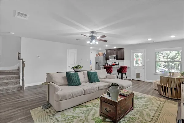 a living room with furniture and wooden floor
