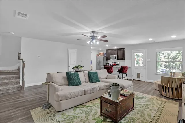 a living room with furniture and wooden floor