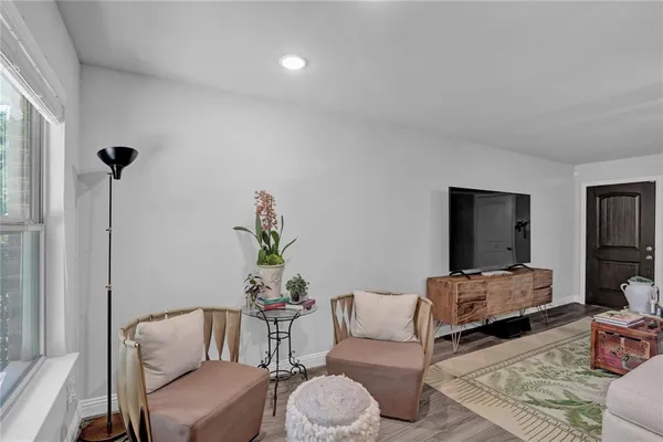 a living room with furniture and a potted plant