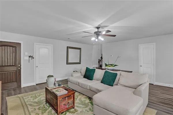 a living room with furniture and a chandelier
