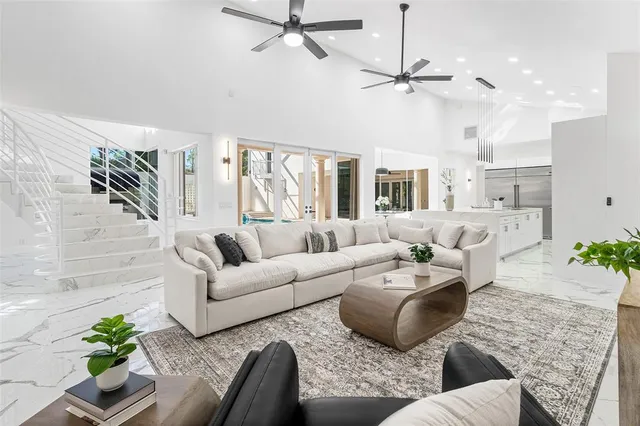 a living room with furniture and a chandelier