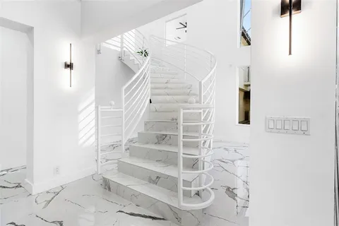 a view of staircase with white walls